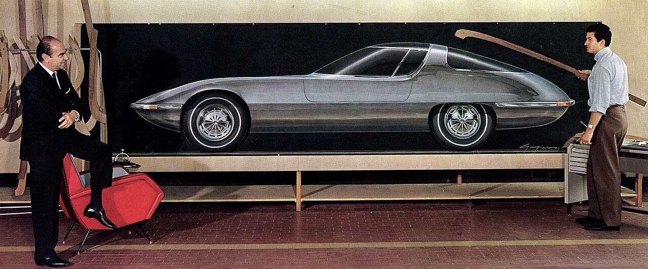 Nuccio Bertone and Giorgetto Giugiaro standing next to a design drawing of the Testudo