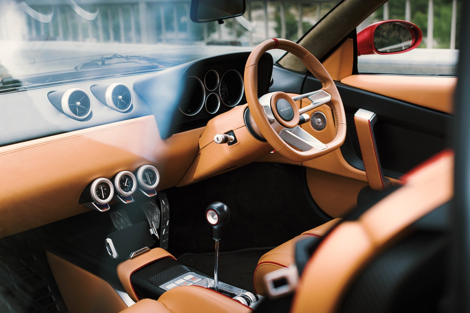 Interior view of a luxury car featuring a stylish dashboard, steering wheel, and leather seating.