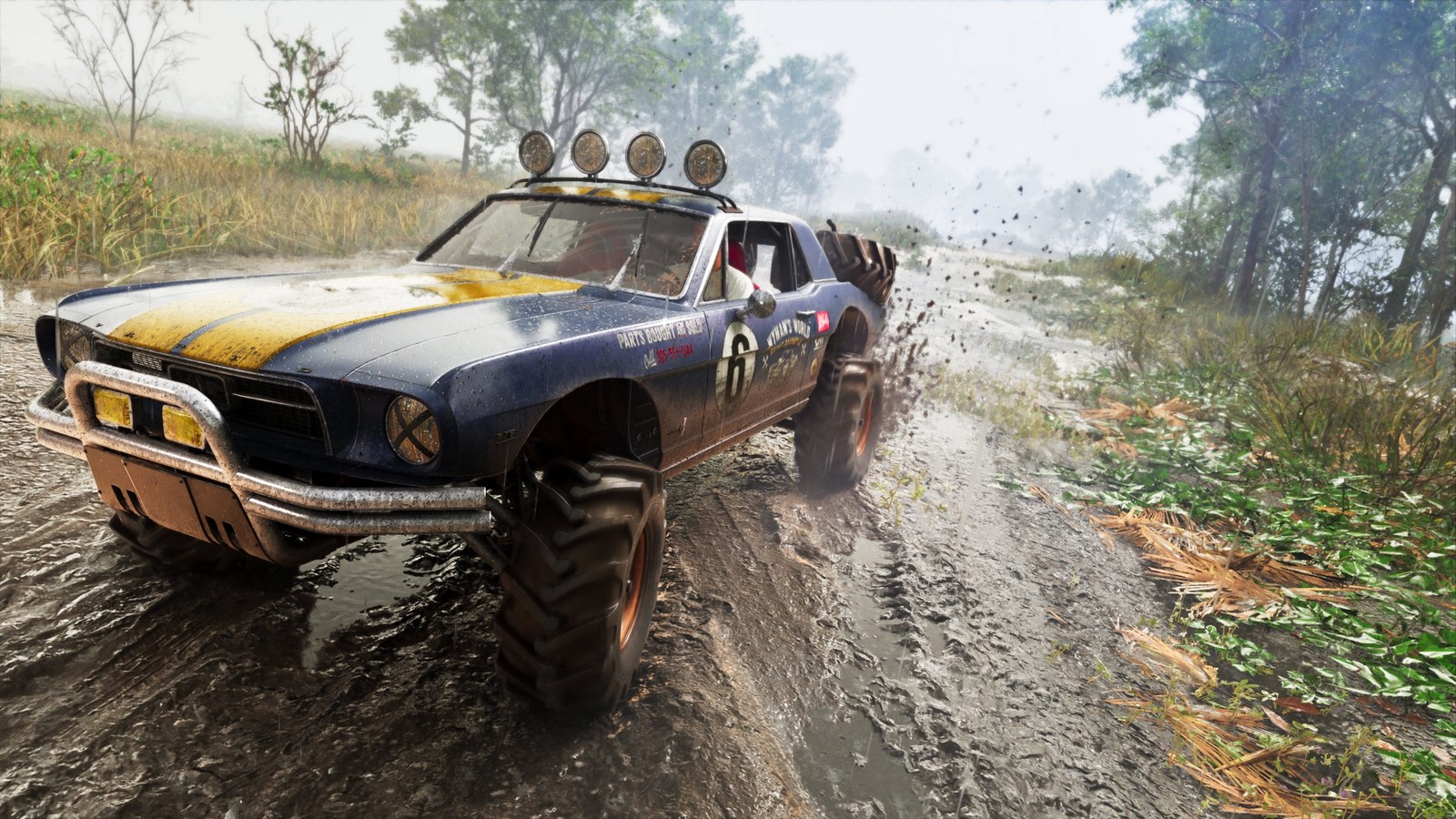 Off-road vehicle navigating a muddy track surrounded by greenery and trees. Off-road vehicle navigating a muddy track surrounded by greenery and trees.