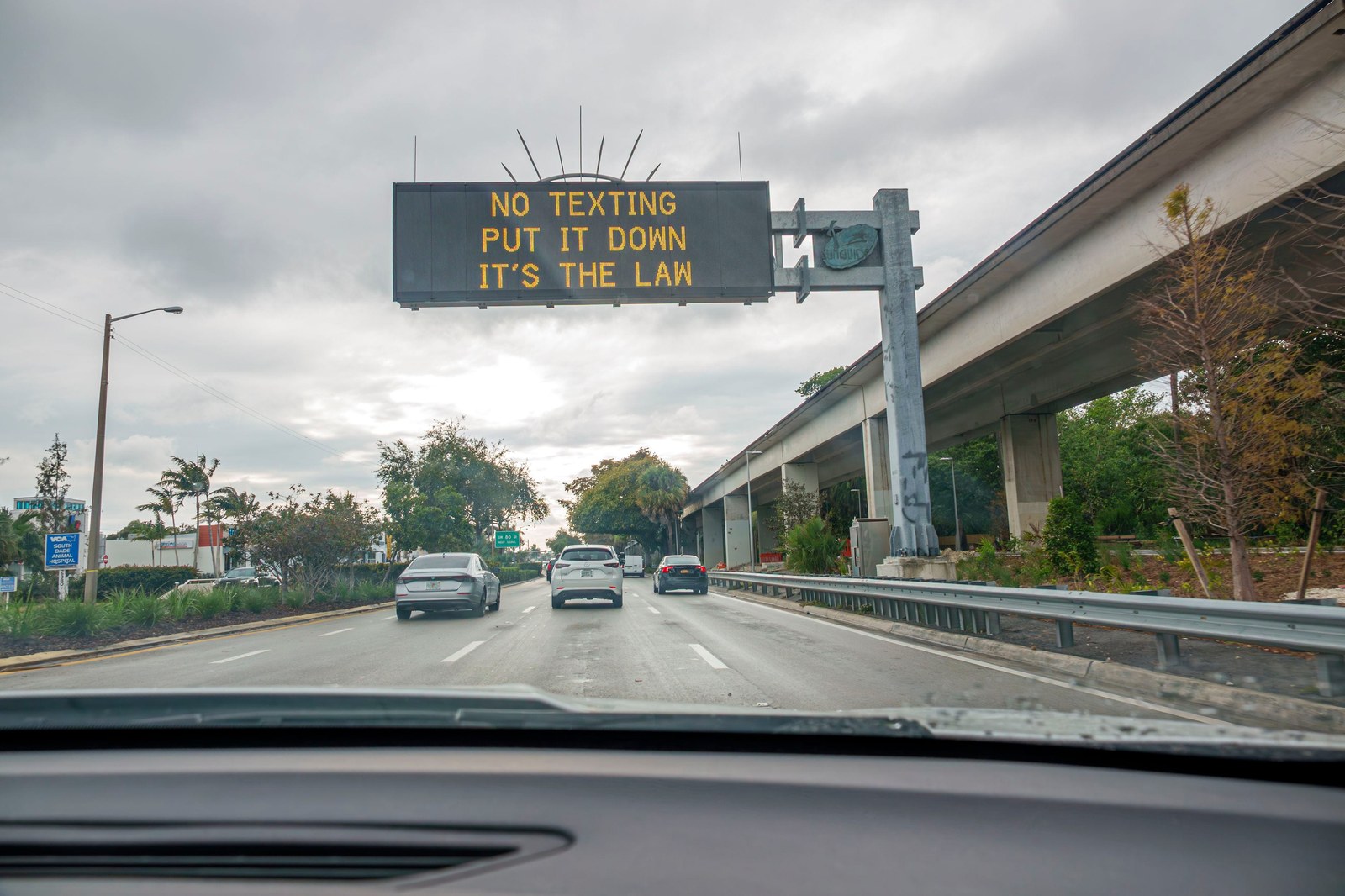Miami, Florida, South Dixie Highway Route 1, overhead electronic road sign, no texting put it down its the law