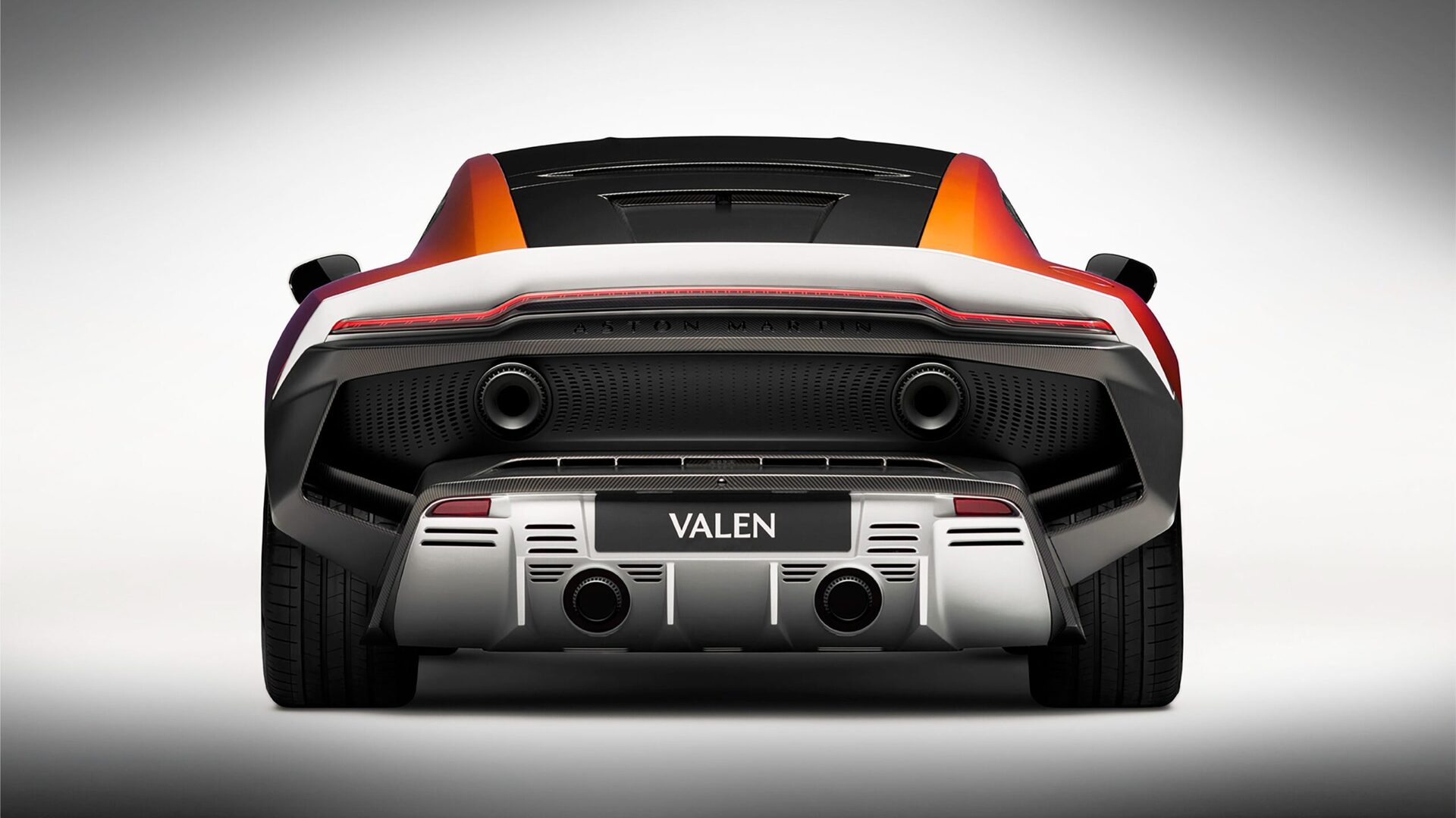 Rear view of a sleek, modern sports car with distinctive design elements and dual exhausts.