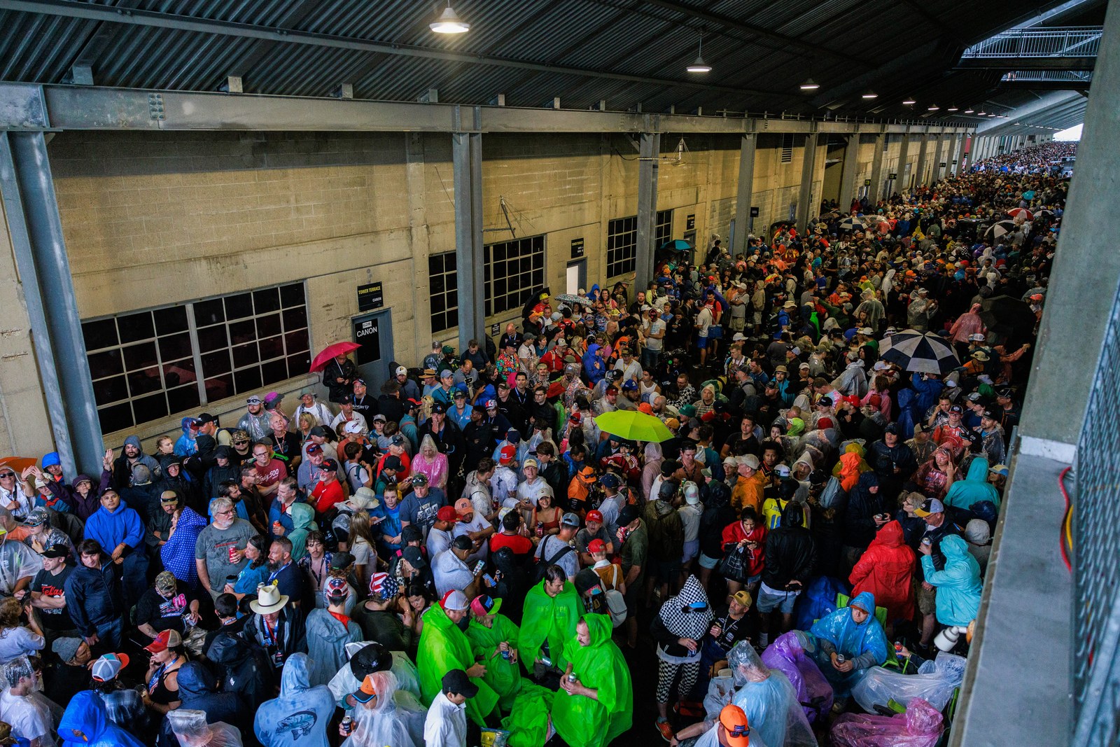 Fans take shelter during a rain delay before the 2024 Indy Fans take shelter during a rain delay before the 2024 Indy