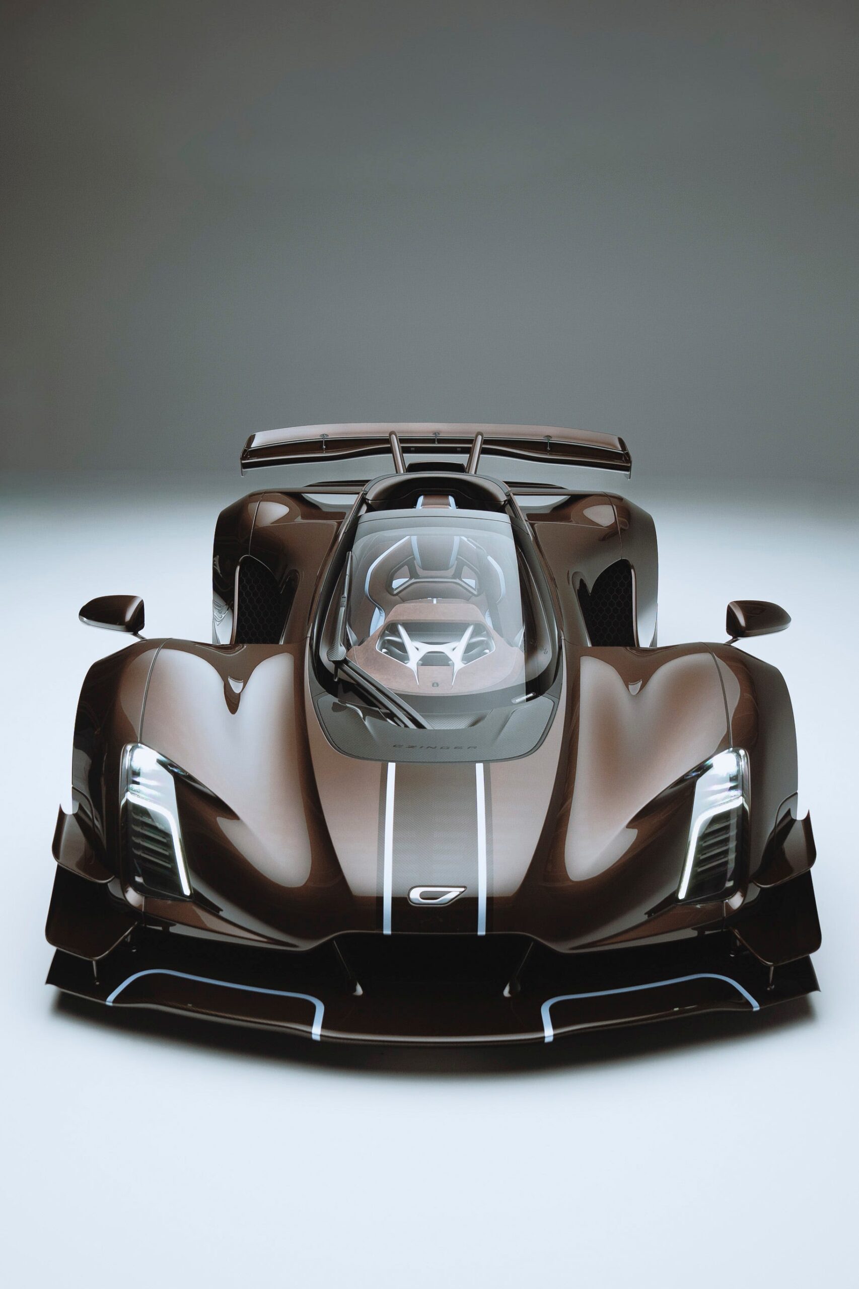 Sleek brown supercar with a transparent roof and striking aerodynamic design on a plain background.