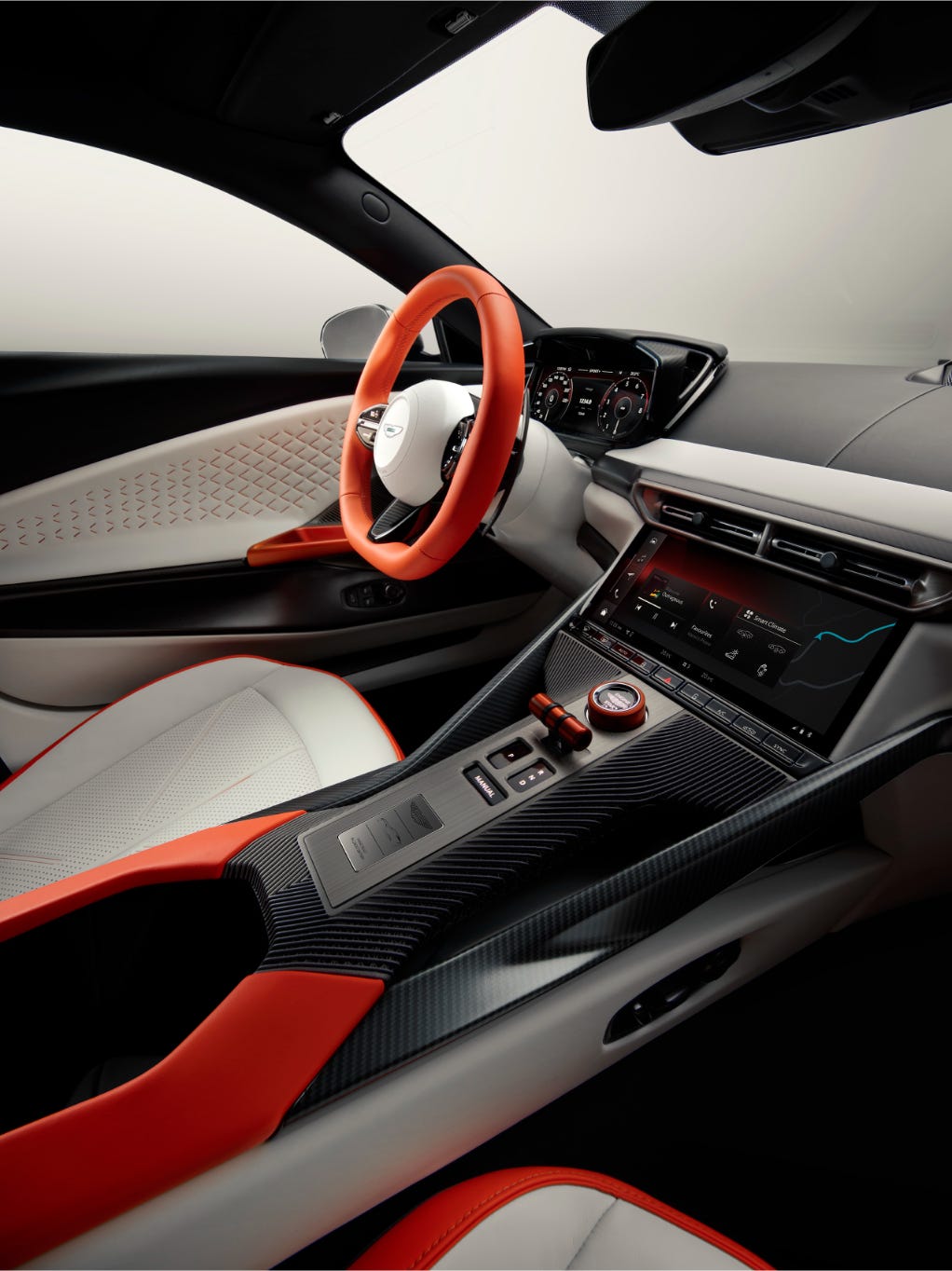 Interior of a car featuring a modern dashboard, sleek design, and a sporty steering wheel with red accents.