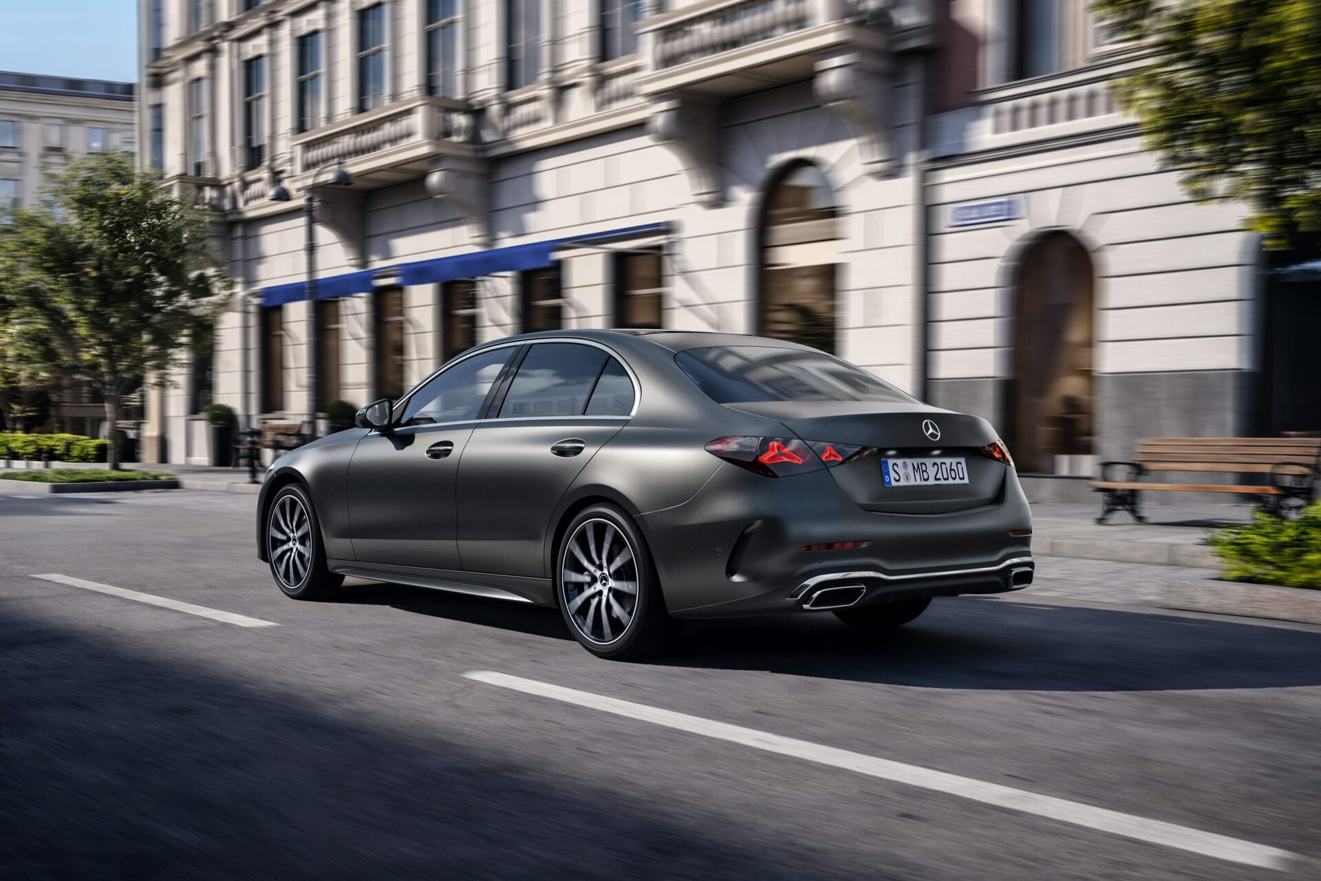 A sleek gray sedan driving past elegant urban architecture. A sleek gray sedan driving past elegant urban architecture.
