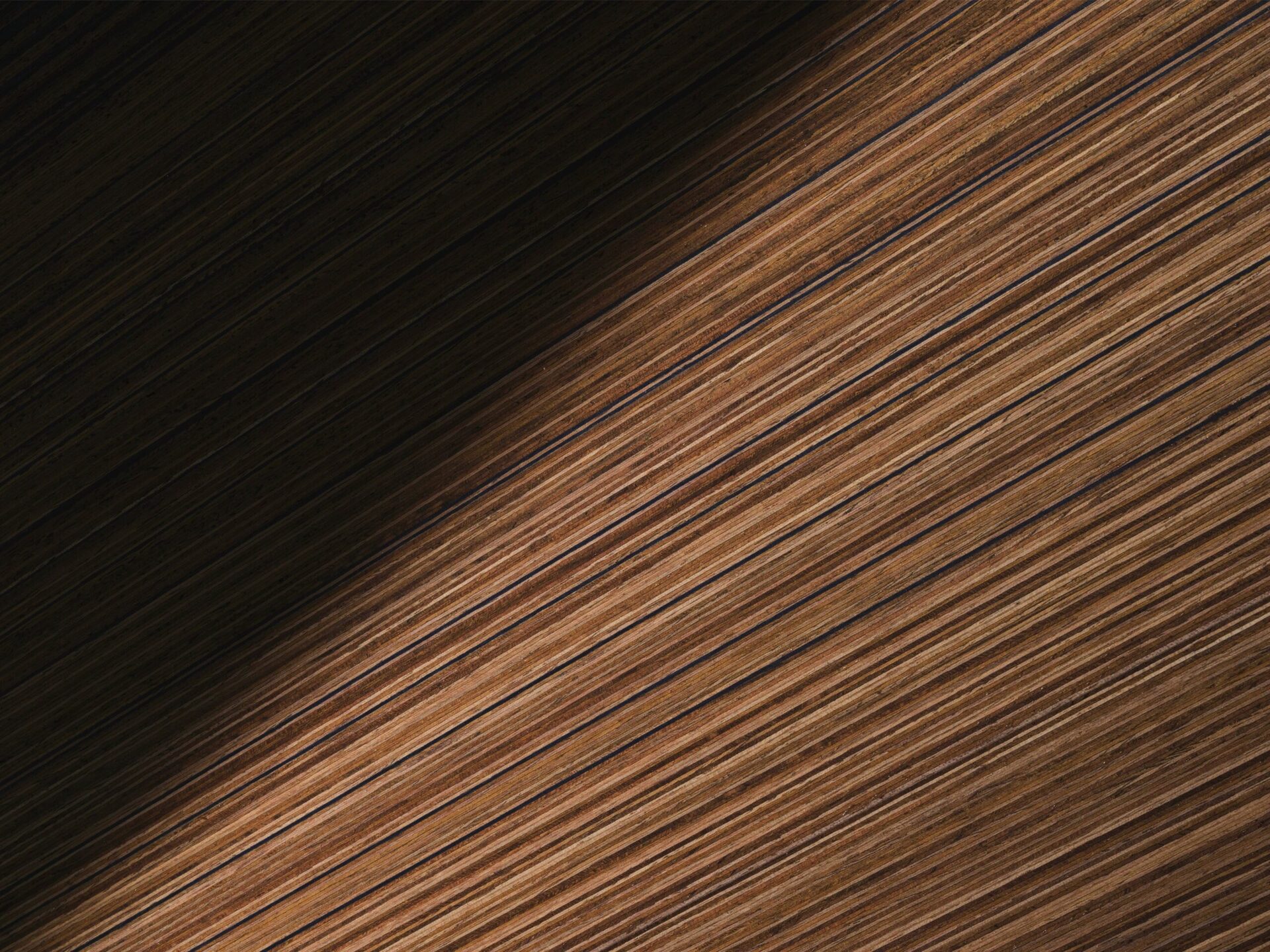Abstract texture of layered brown materials with light and shadow contrast.