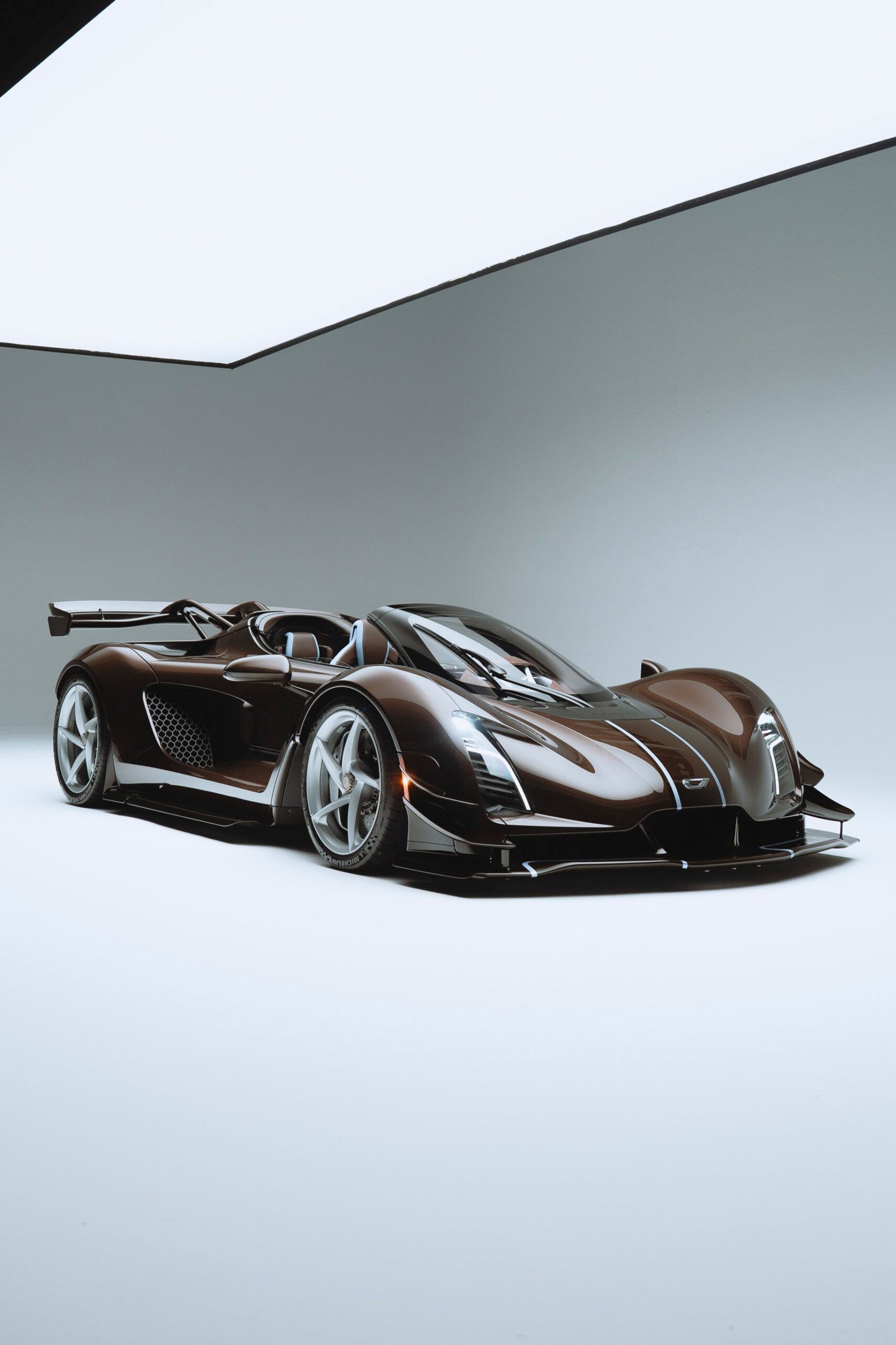 Sleek brown hypercar displayed in a minimalistic studio setting with white background. Sleek brown hypercar displayed in a minimalistic studio setting with white background.
