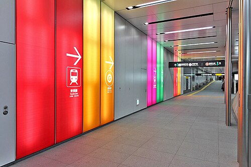 Color-coded wall paneling helps passengers inside the Tokyo Metro Fukutoshin Line's Shibuya Station to navigate passages to connecting rail lines. Shibuya is the fourth busiest station on the Tokyo Metro network and a major interchange with Tōkyū, Keiō, and JR East trains.