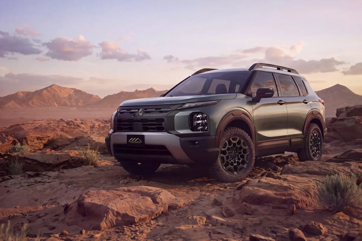 Green SUV in a rocky desert landscape with mountains and a sunset sky. Green SUV in a rocky desert landscape with mountains and a sunset sky.