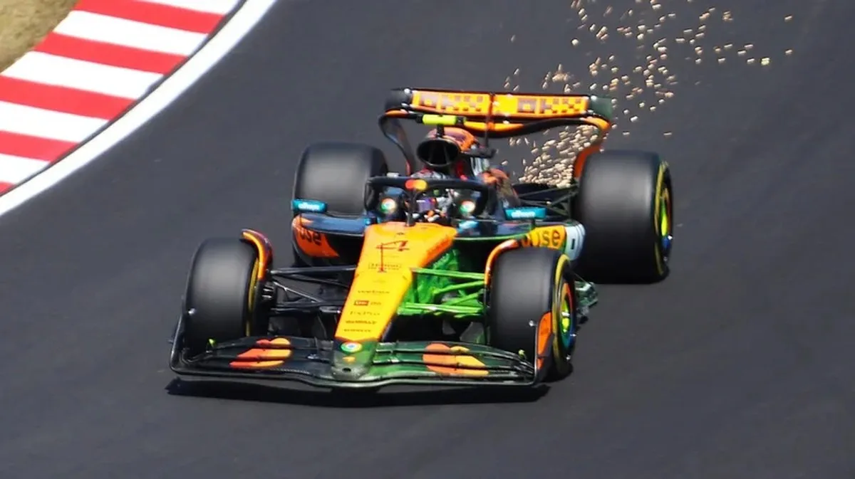 Lando Norris in his orange and black 2025 McLaren MCL39 Formula 1 car, driving on a Japanese race track