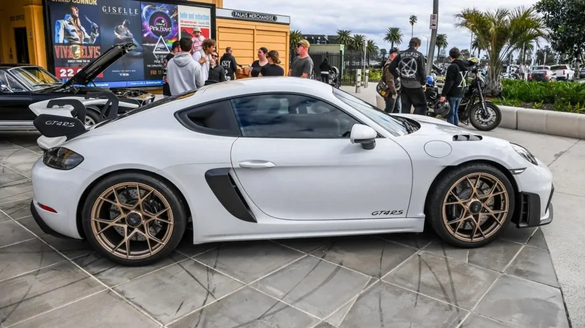 A white Porsche 718 Cayman GT4 RS with center lock wheels