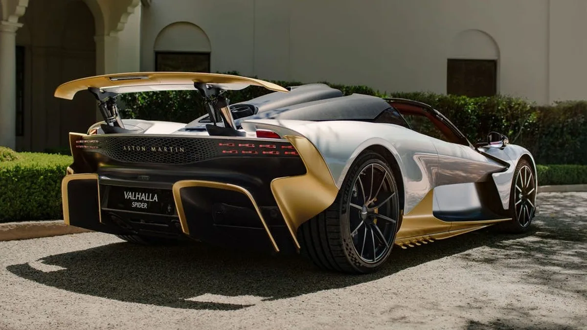 Aston Martin Valhalla Spider parked in a scenic setting with sleek design and distinctive gold and silver colors.