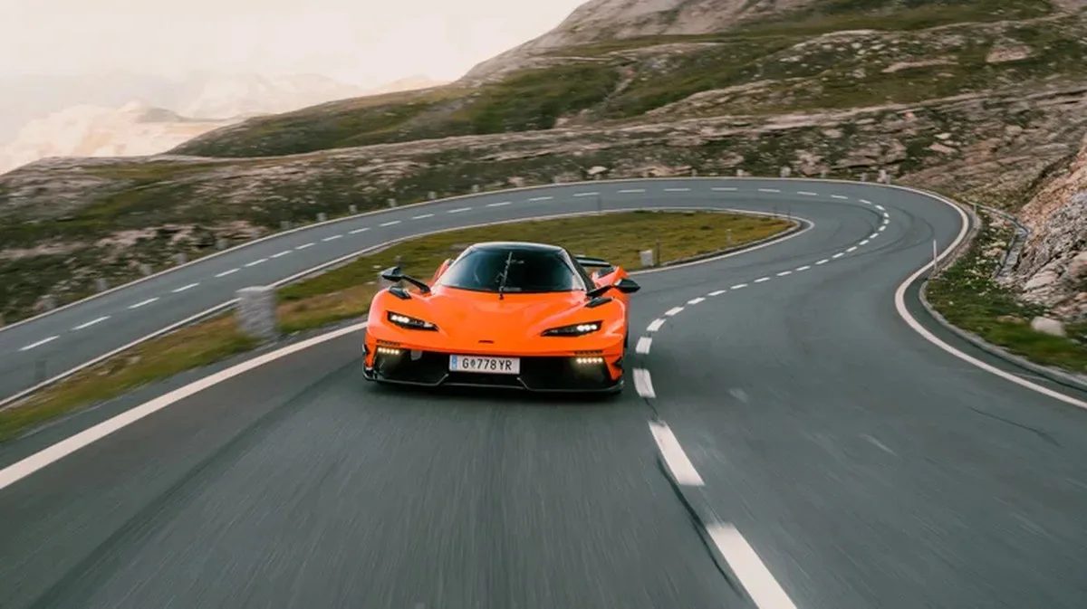 An orange KTM X-Bow GT-XR driving on a mountain road