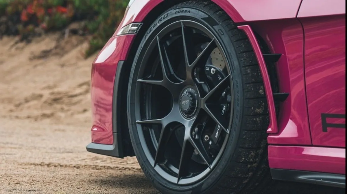 close-up of the front wheel on a Ruby Star Neo 911 S/T parked on dirt