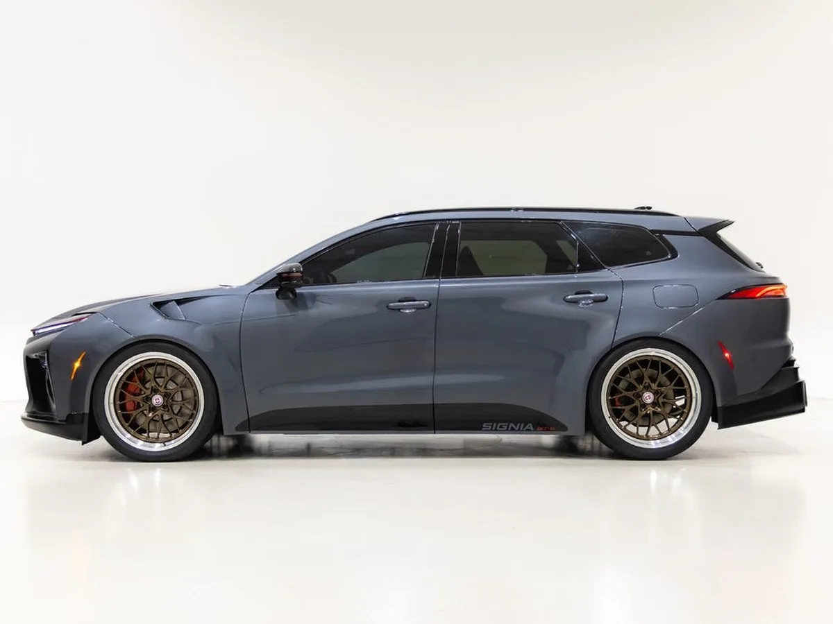 Sporty gray car with distinctive wheels and a lowered stance against a plain background.