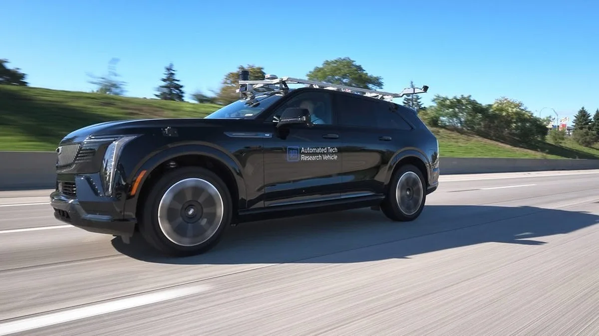 Black automated research vehicle driving on a highway with a clear blue sky in the background. Black automated research vehicle driving on a highway with a clear blue sky in the background.