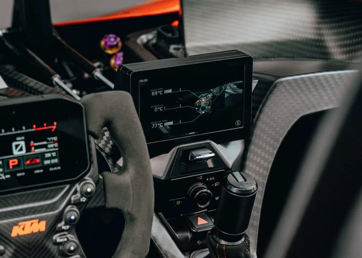 Dashboard view of a sports car with digital display showing engine and fluid temperatures. Dashboard view of a sports car with digital display showing engine and fluid temperatures.