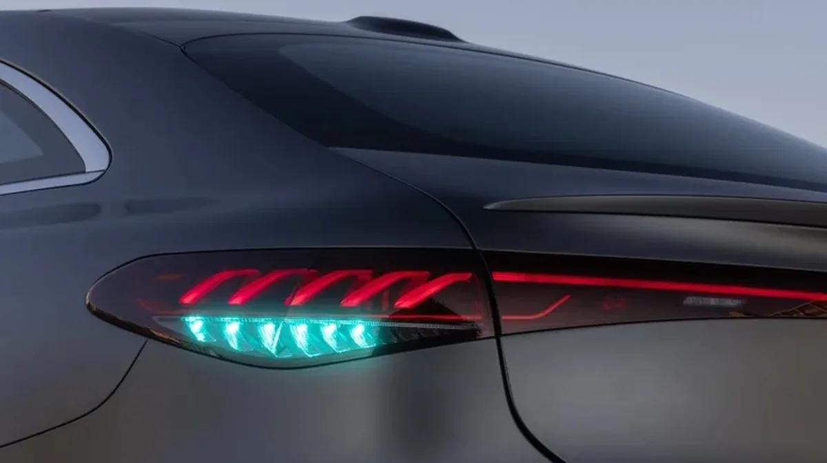 Close-up of the cyan rear lights on the matte gray Mercedes-Benz EQS