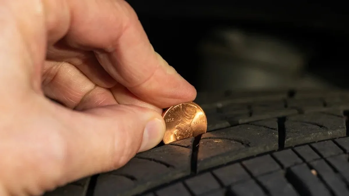 Using a penny to check tread depth on a tire