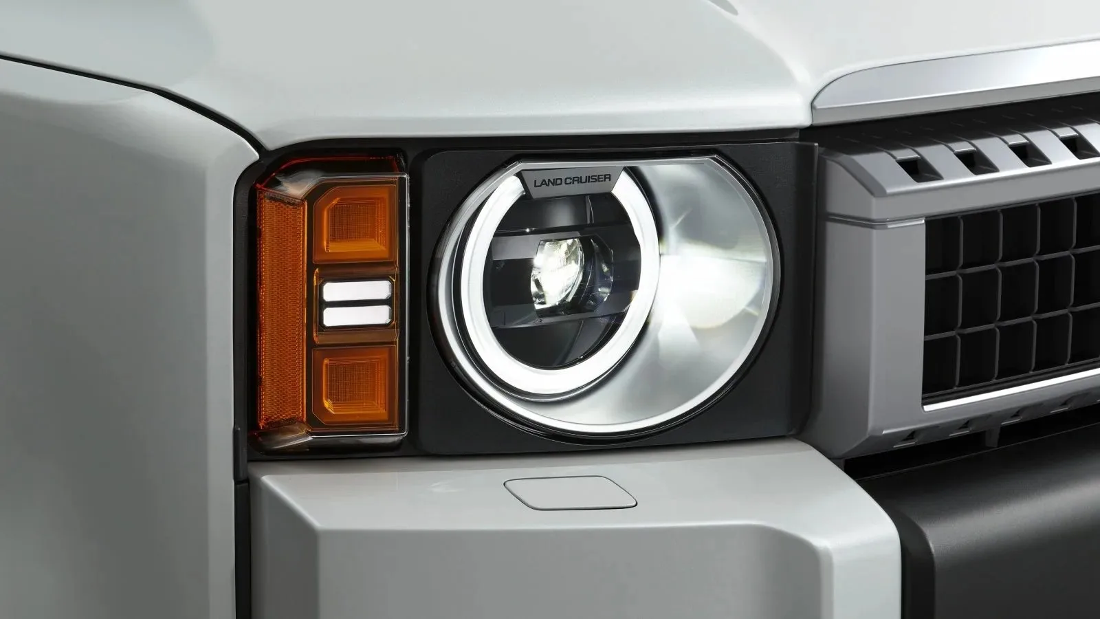 Official close-up illustration of the round-headlamp unit.