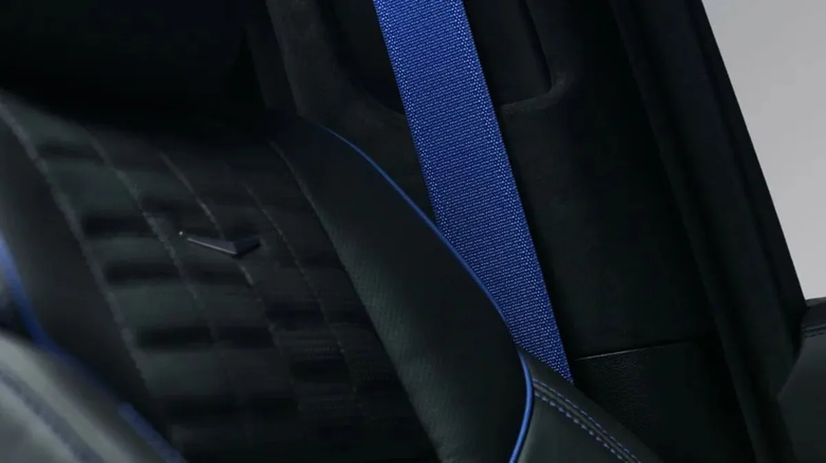Close-up of the black interior of the special edition Escalade showing the blue stitching, seat piping, and seat belt