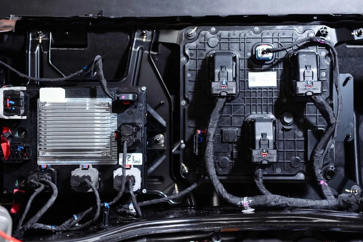Electrical components and connectors mounted in a vehicle's engine compartment.