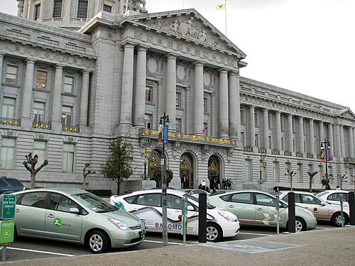 Several plug-in converted Toyota Priuses hybrids recharging at the public stations in front of San Francisco City Hall.