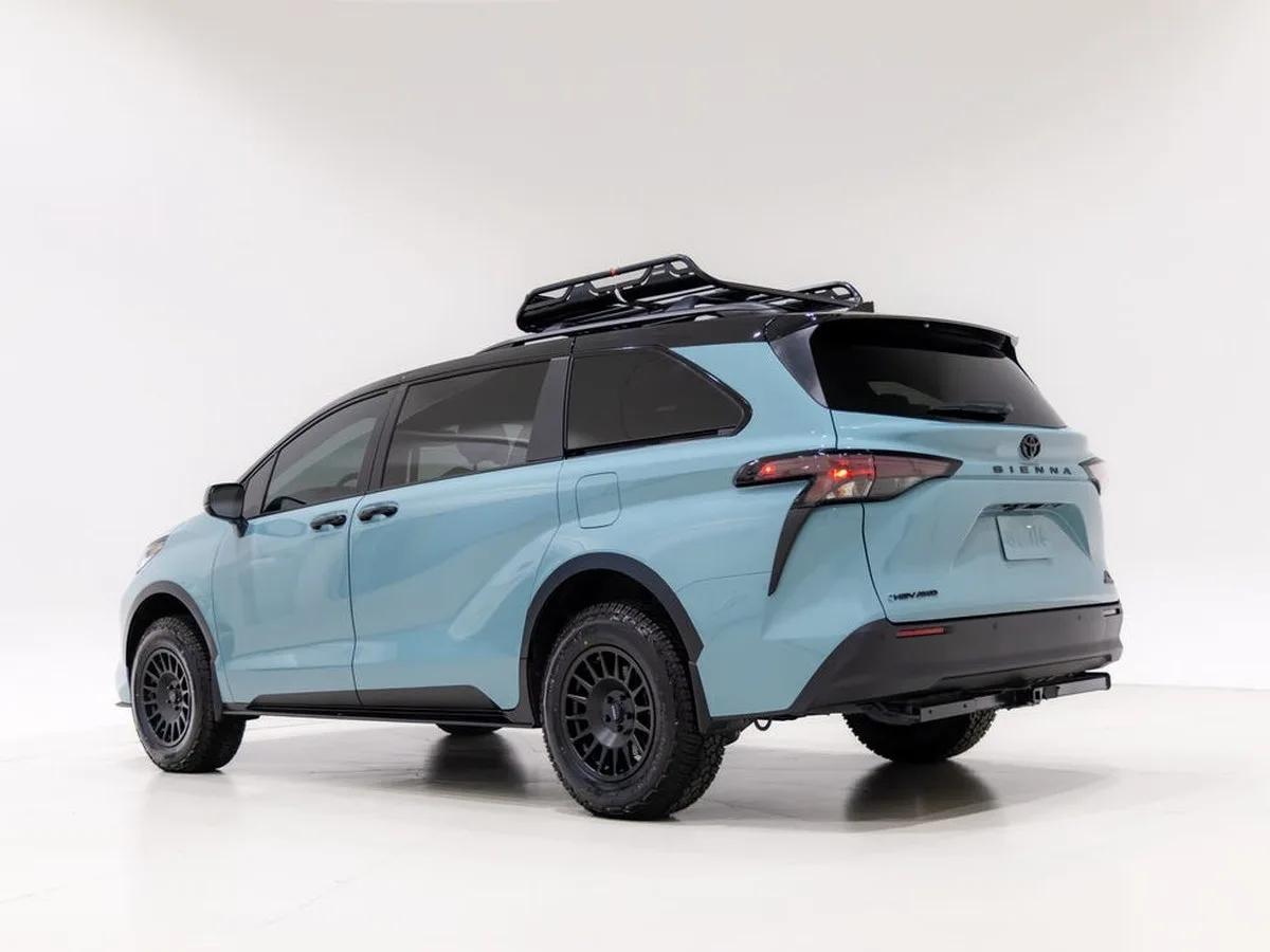 Blue Toyota Sienna minivan with a roof rack, parked against a plain white background. Blue Toyota Sienna minivan with a roof rack, parked against a plain white background.
